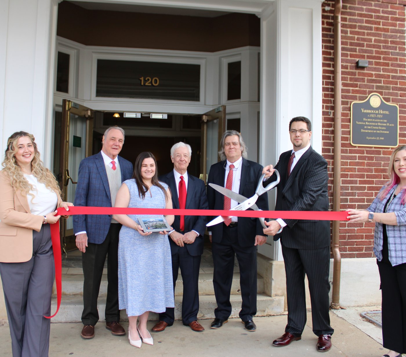 The firm's team at the entrance of 120 Holmes Avenue NE — the historic Yarbrough Hotel building in downtown Huntsville